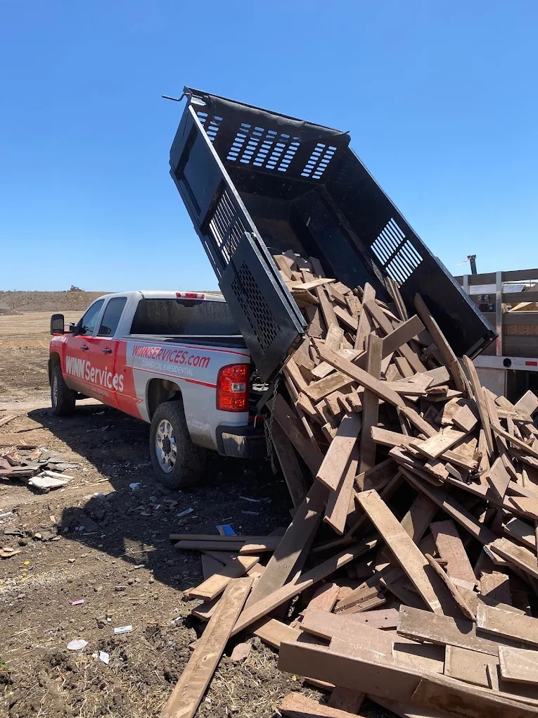 WINN Services dump truck unloading wood debris